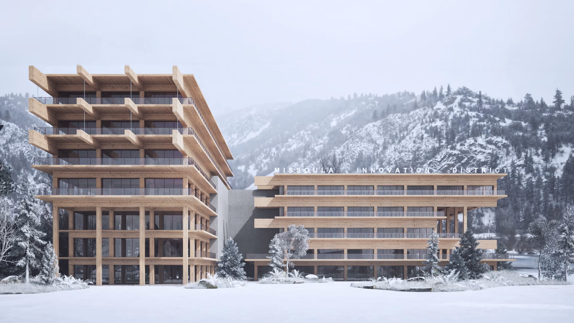 Two timber-framed buildings around a snowy courtyard beneath a wooded hillside